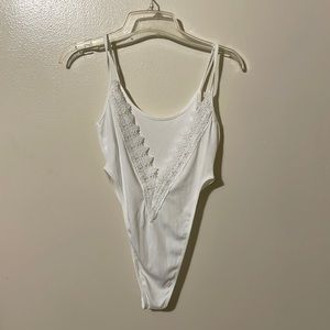 Brand new body suit with low back